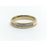 An 18ct yellow gold half eternity ring having a row of nine diamonds, approx 0.33ct, ring size