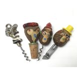 An Andy Capp corkscrew and a set of three bar utensils with carved animal heads