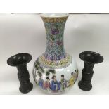 An Oriental vase of squat form decorated with figures in a garden setting and four character marks