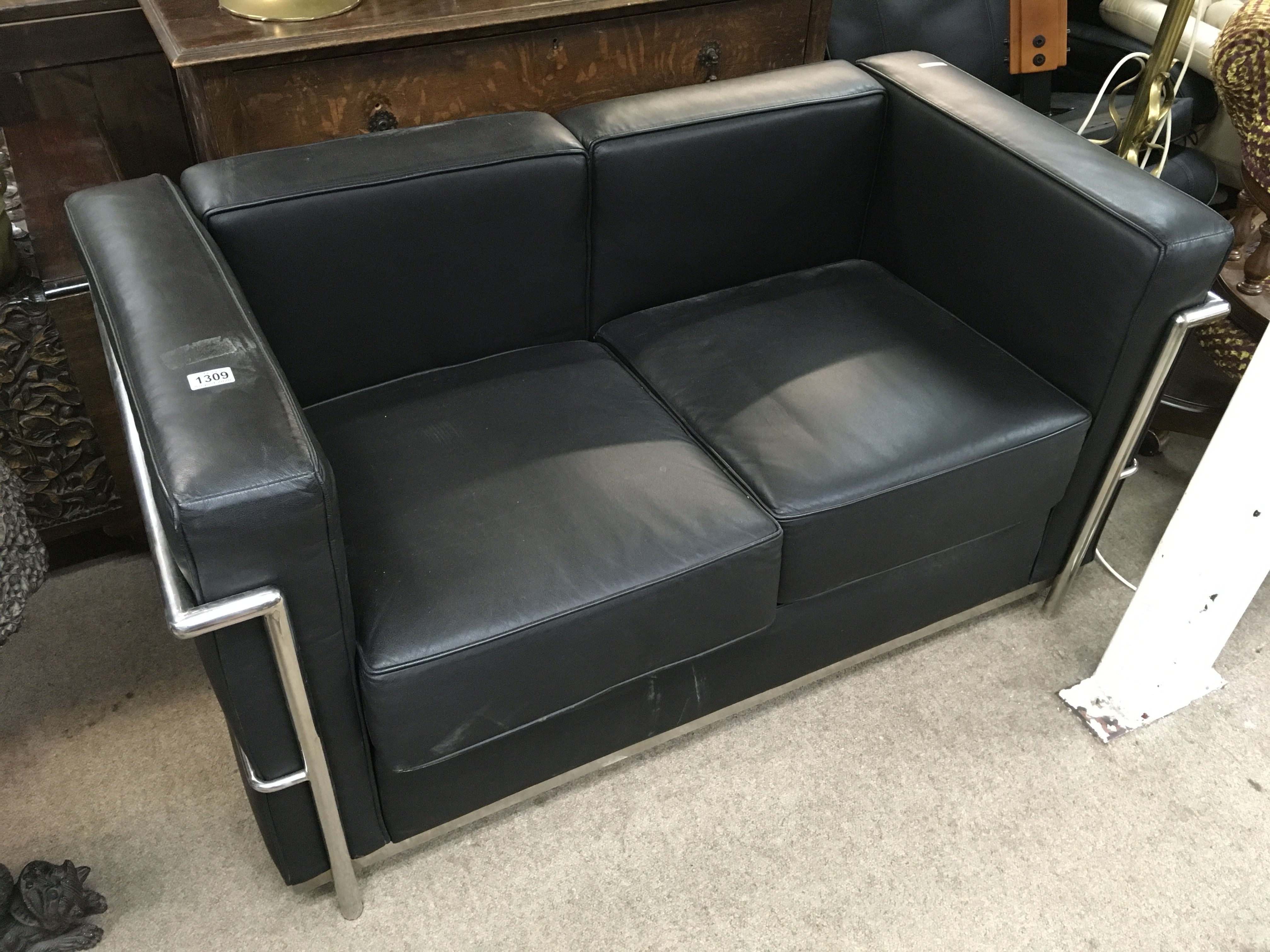 A modern black leather and chrome 2 seater sofa, 125 x 67 x 70cm