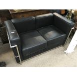 A modern black leather and chrome 2 seater sofa, 125 x 67 x 70cm