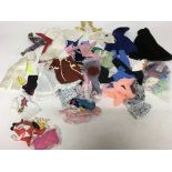 A box containing a collection of loose dolls clothing suitable for Sindy , Barbie etc