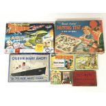 A collection of boxed games including Remote control Driving test, Queen Mary Ahoy, Peepscope, Tut