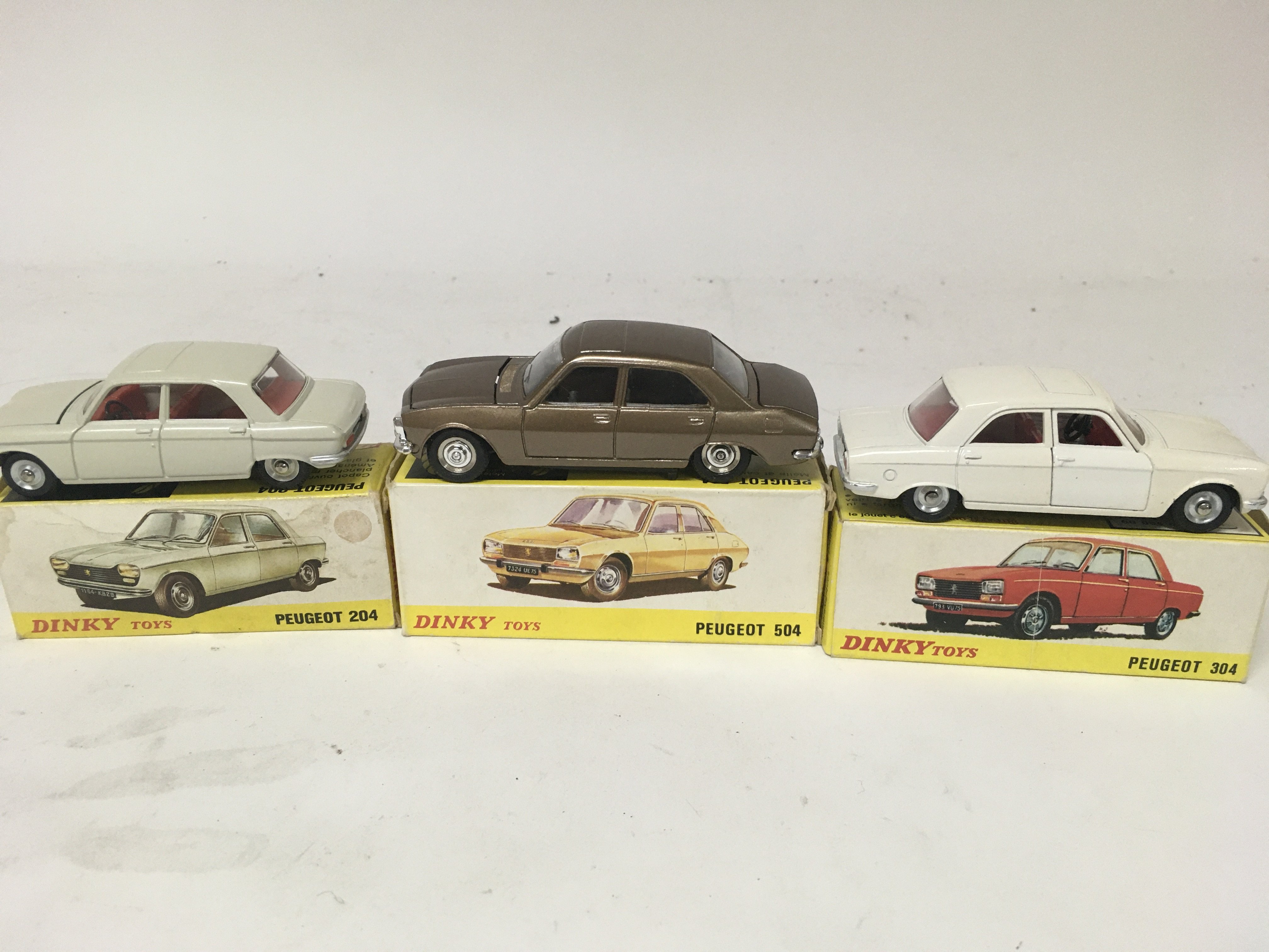 Dinky toys, #510 Peugeot 204, #011452 Peugeot 504 and #1428 Peugeot 304, boxed