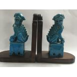 A pair of Chinese dogs of fo on wooden stands .