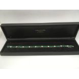 A quality 18ct gold diamond and emerald bracelet,