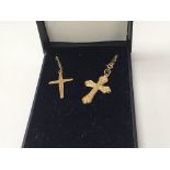 A 9carat gold cross pendent with attached chain an