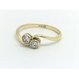 An 18ct yellow gold ring with two diamonds, ring s