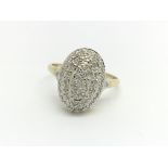 A 9ct yellow gold oval shaped ring with diamond cl