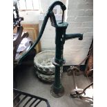 A green painted cast iron water pump, 136cm.
