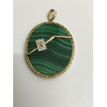 A oval malachite pendant surrounded with a 14 k go