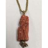 A carved coral pendent in the form of a Chinese Sa