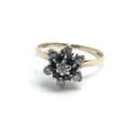 A 9ct yellow gold sapphire and diamond cluster rin