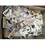 A box of mixed cigarette cards