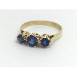 An 18ct yellow gold ring with three blue coloured