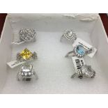 A box of silver rings set with gemstones.