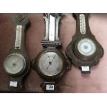 Three small oak cased wall barometers .