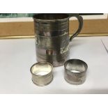 Two silver napkin rings Birmingham and London hallmarks and a silver plated tankard.