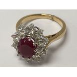 An 18ct yellow gold oval ruby and diamond cluster