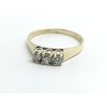 A 9ct yellow gold ring set with a row of three dia