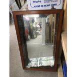 A wall mounted display cabinet with mirrored back,