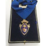 A cased silver gilt and enamel medal.