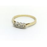 An 18ct yellow gold and three stone diamond ring,