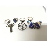 Four silver rings set with amethyst a silver butte