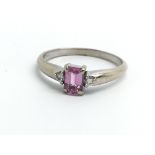 An 18ct white gold ring set with central pink sapp