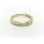 A 9ct yellow gold and diamond half eternity ring,