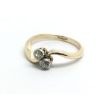 An 18ct yellow gold and two stone diamond ring, ri