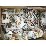 A box of mixed cigarette cards