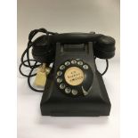 A vintage bakelite telephone.