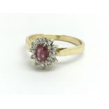 An 18ct yellow gold, ruby and diamond ring, size a