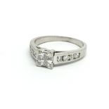 An 18ct white gold ring the central four square di