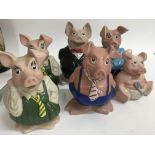A collection of six Wade NatWest pigs .