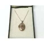 A 9ct gold locket with floral pattern and chain