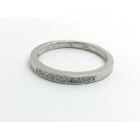 An 18ct white gold and small diamond half eternity
