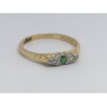 A vintage diamond and emerald ring, size approx K/