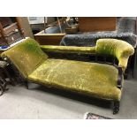 A carved and upholstered Victorian chaise lounge.