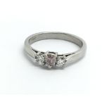 A platinum ring set with central pink diamond and