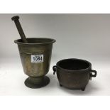 A bronze mortar and pestle and a Chinese bronze ve