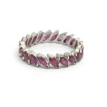 An 18ct white gold and ruby full eternity ring, si