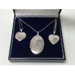 Three silver lockets on chains, two heart shaped a