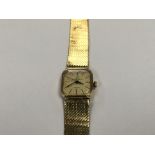 A ladies 9carat gold watch with attached 9carat go