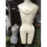 A mannequin on stand and a dress makers dummy .