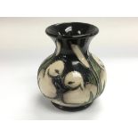A small Moorcroft vase depicting signets, signed t