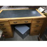 A large 1970s oak pedestal desk with