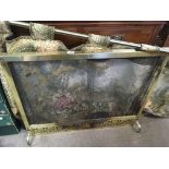 A 1920s brass and wire mesh curtain fire screen to