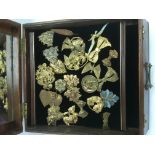 A box of copper and brass jewellery items.